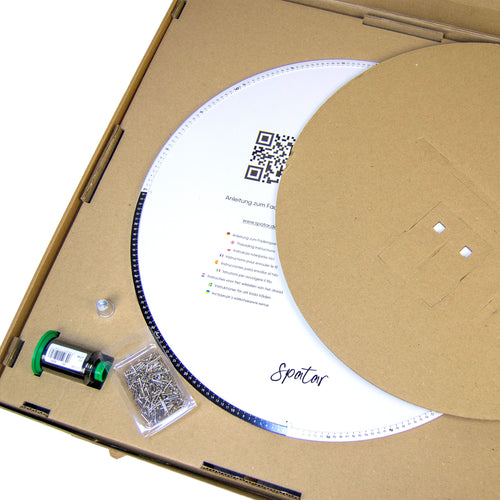 Open String Art DIY kit showing circular base, nails, thread, and instruction insert inside the box