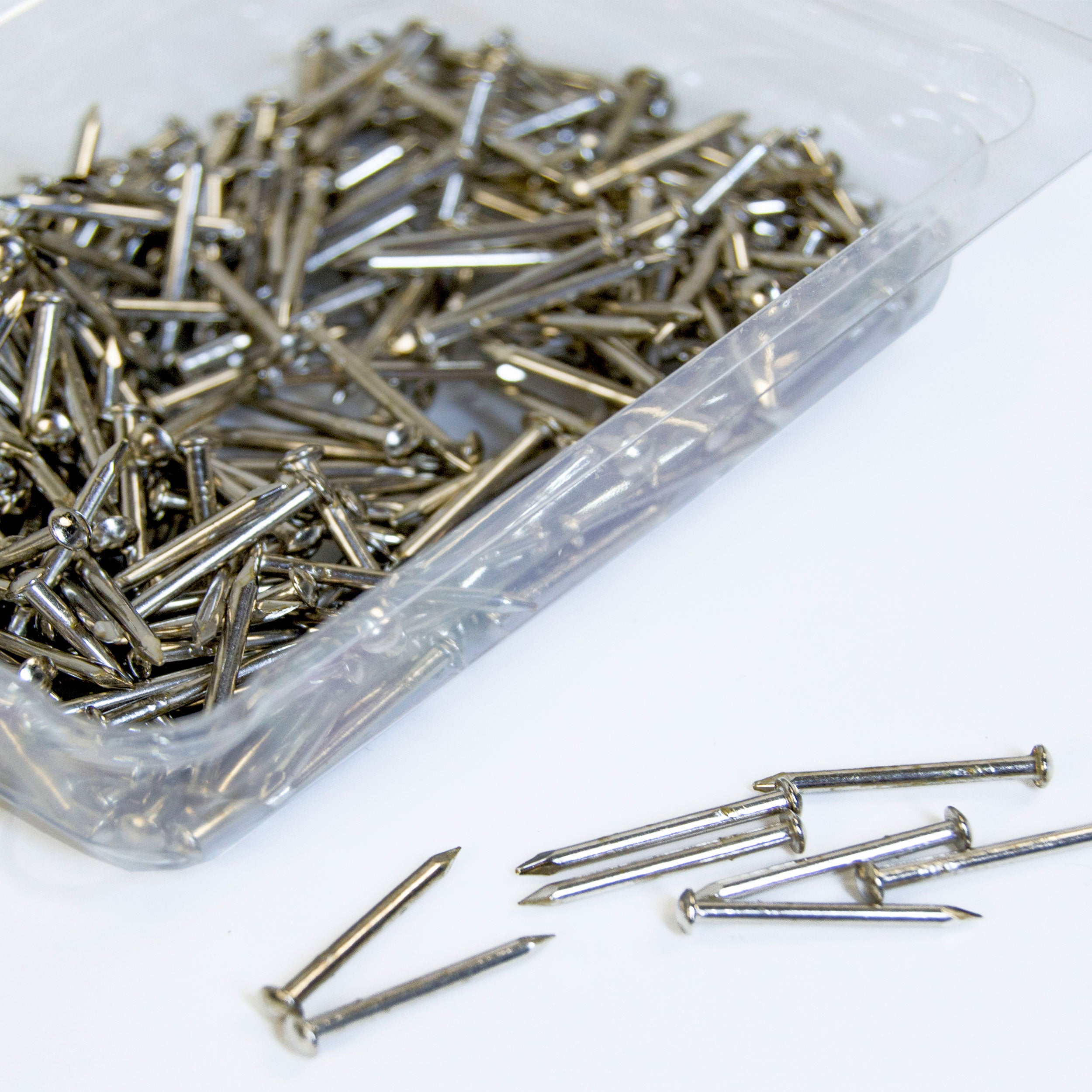 Set of metal nails included in a string art DIY kit, shown ready for use